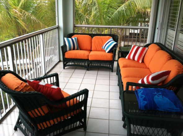 New cushions on sitting area furniture on screened porch. 